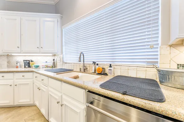 a kitchen with sink and cabinets