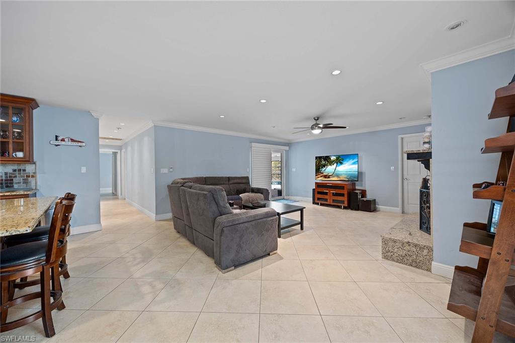 6574 Trail Boulevard Naples, FL 34108 - Photo 15 of 40 a living room with furniture and a couch