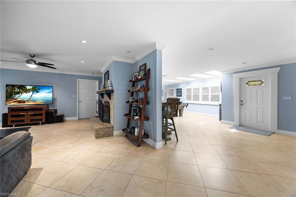 6574 Trail Boulevard Naples, FL 34108 - Photo 18 of 40 a view of a livingroom with furniture and a flat screen tv
