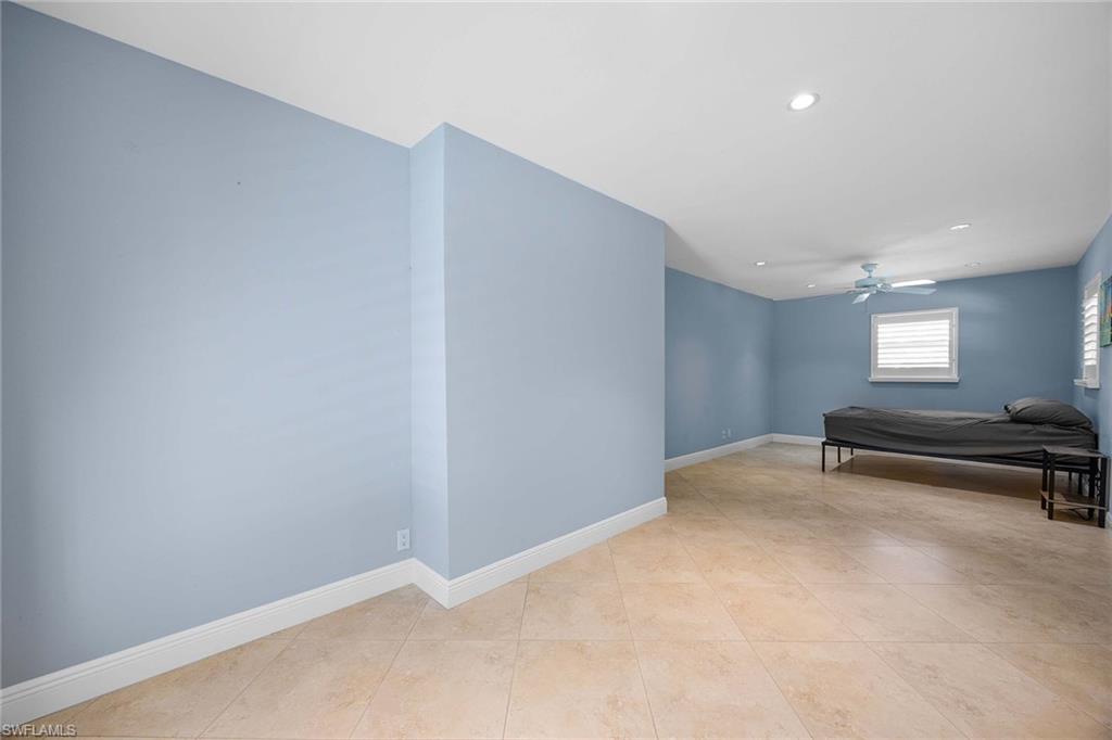 6574 Trail Boulevard Naples, FL 34108 - Photo 26 of 40 a view of an empty room with a window