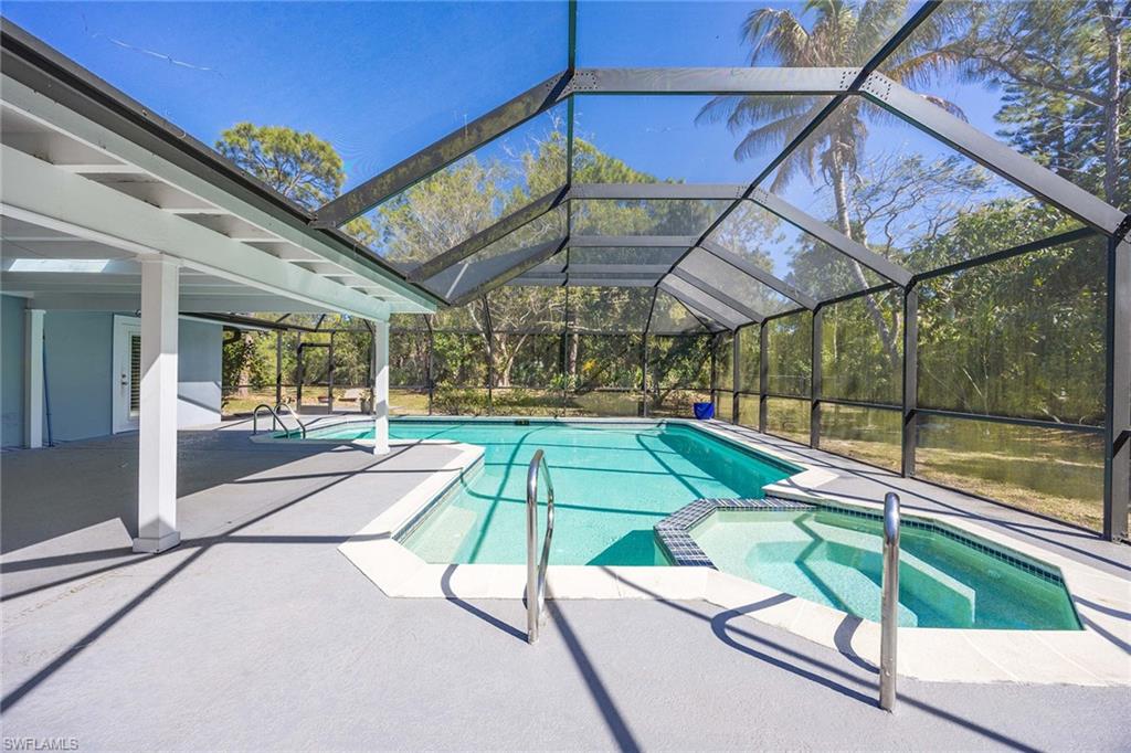 6574 Trail Boulevard Naples, FL 34108 - Photo 28 of 40 a room with pool side view