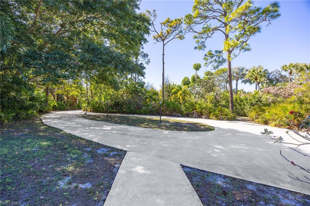 6574 Trail Boulevard Naples, FL 34108 - Photo 32 of 40 a view of a yard with plants and trees