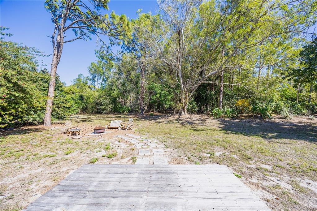 6574 Trail Boulevard Naples, FL 34108 - Photo 36 of 40 a view of a yard with an trees