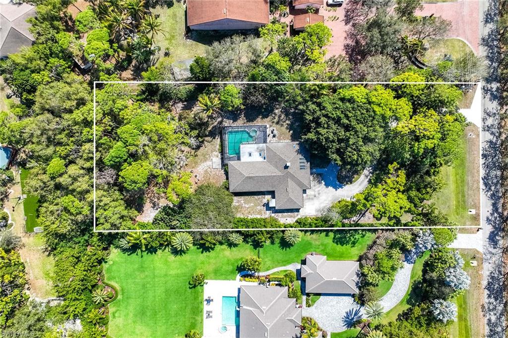 6574 Trail Boulevard Naples, FL 34108 - Photo 5 of 40 an aerial view of a house with a yard
