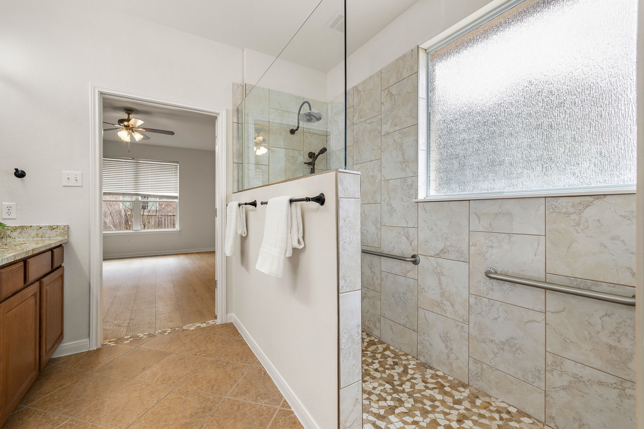 903 Fork Ridge Path Round Rock, TX 78665 - Photo 16 of 27 Primary bathroom with a large walk-in shower.