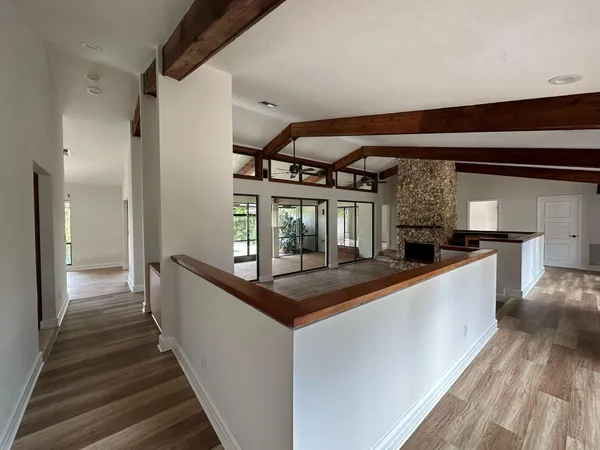 a view of entryway and hall with wooden floor
