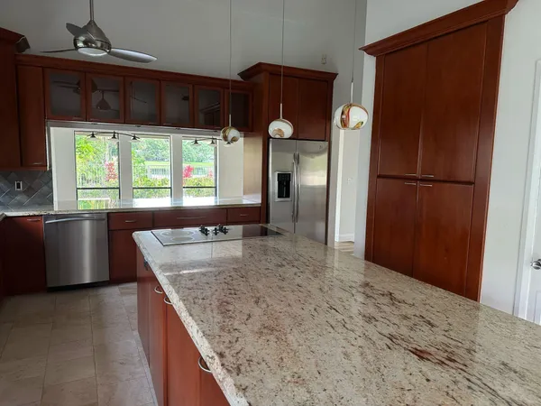 a kitchen with refrigerator and window