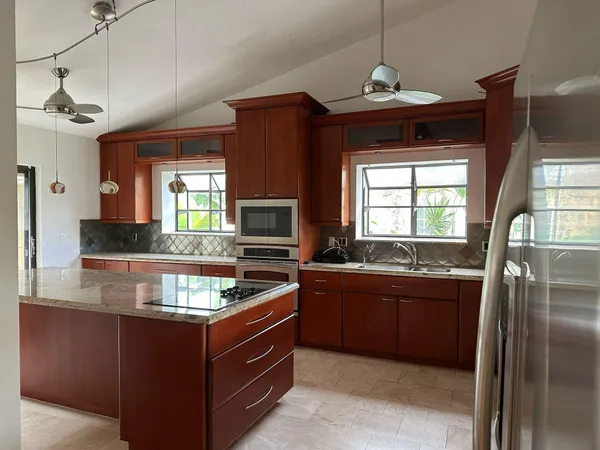 a kitchen with granite countertop a sink and a stove