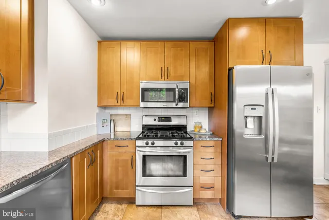 a kitchen with a refrigerator and a stove