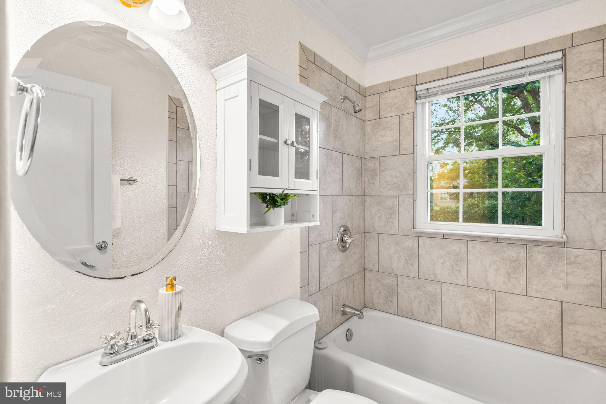 10603 South Dunmoor Drive Silver Spring, MD 20901 - Photo 12 of 41 a bathroom with a sink a toilet and shower