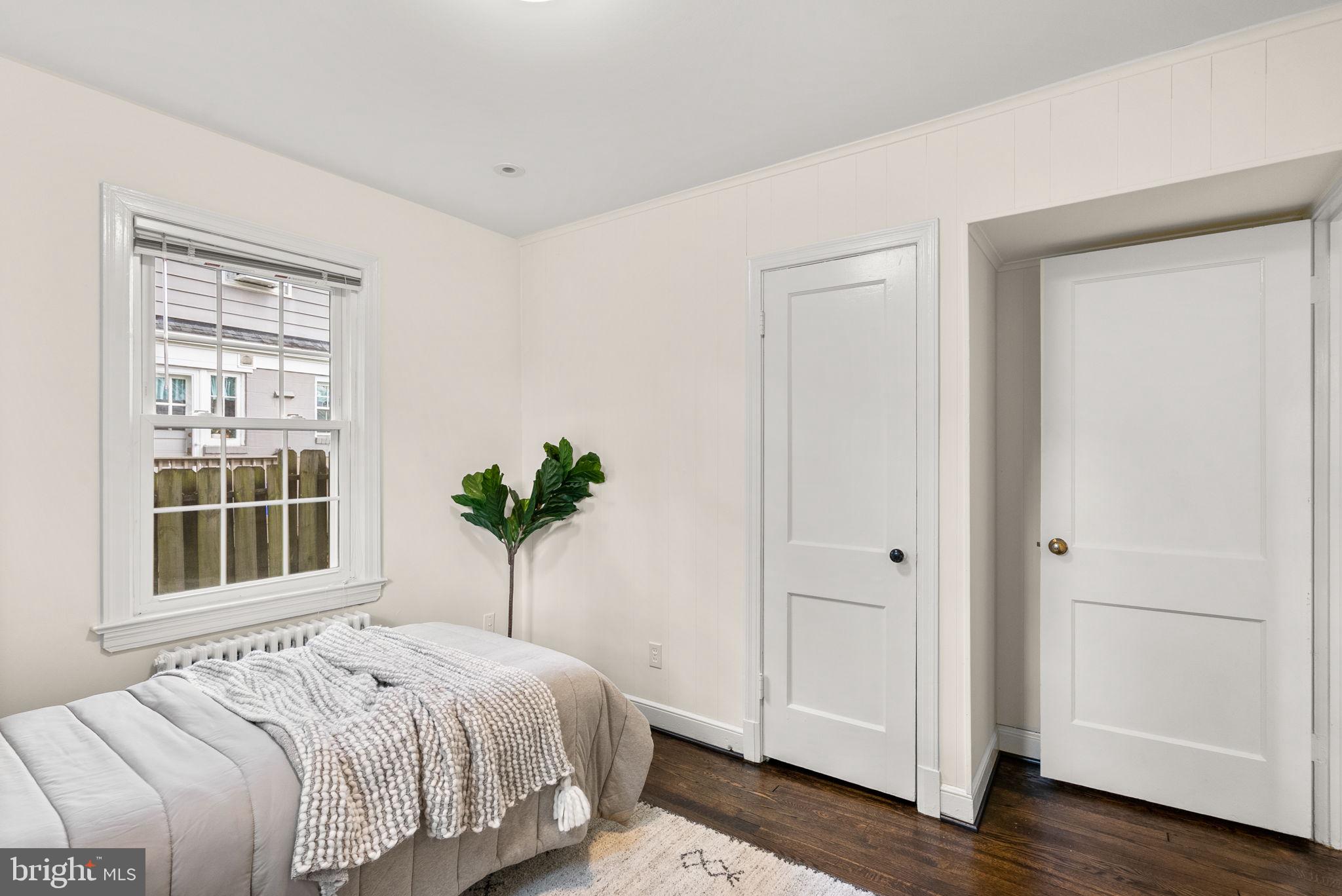 10603 South Dunmoor Drive Silver Spring, MD 20901 - Photo 14 of 41 a bedroom with a bed and a potted plant