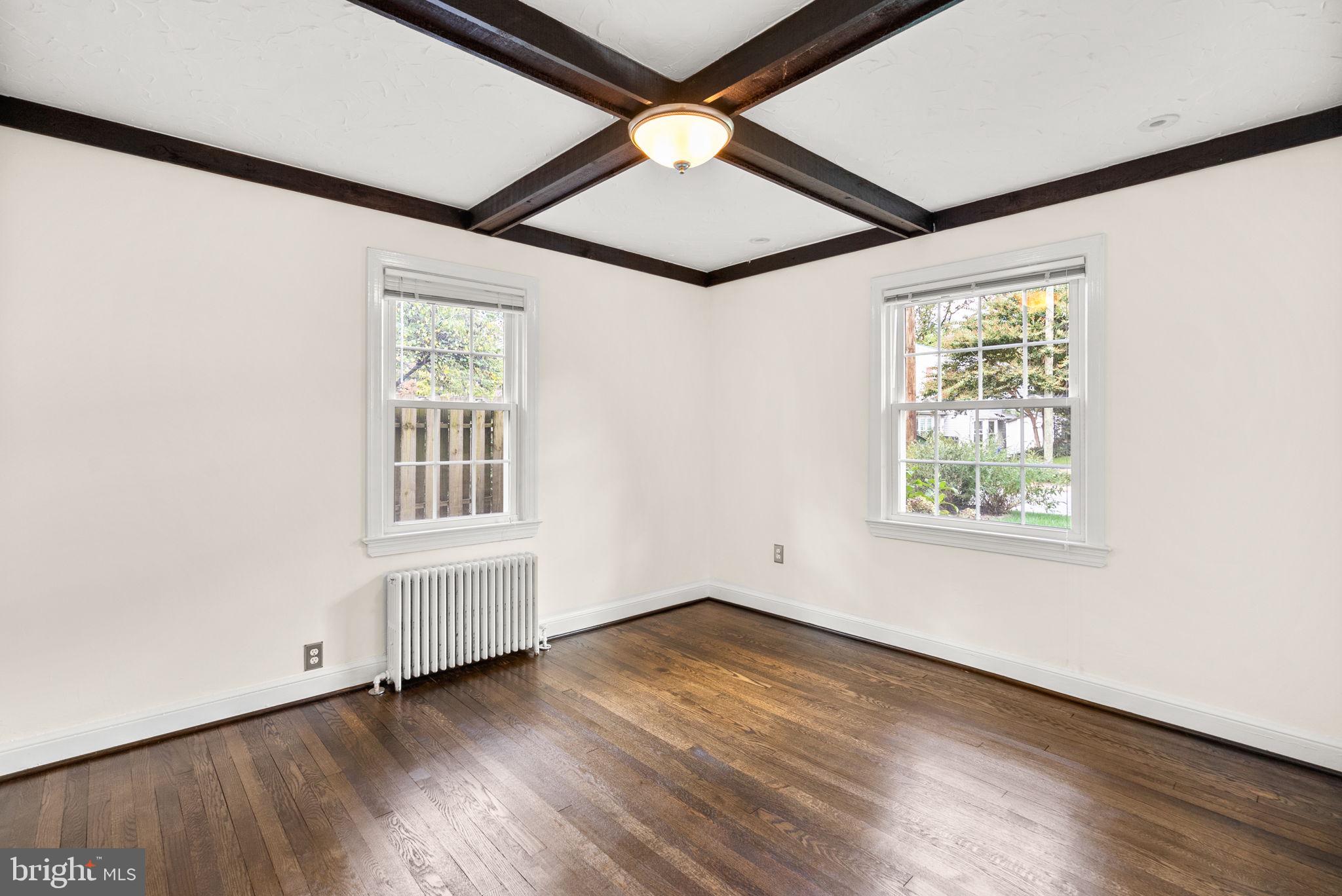 10603 South Dunmoor Drive Silver Spring, MD 20901 - Photo 15 of 41 an empty room with wooden floor chandelier fan and windows