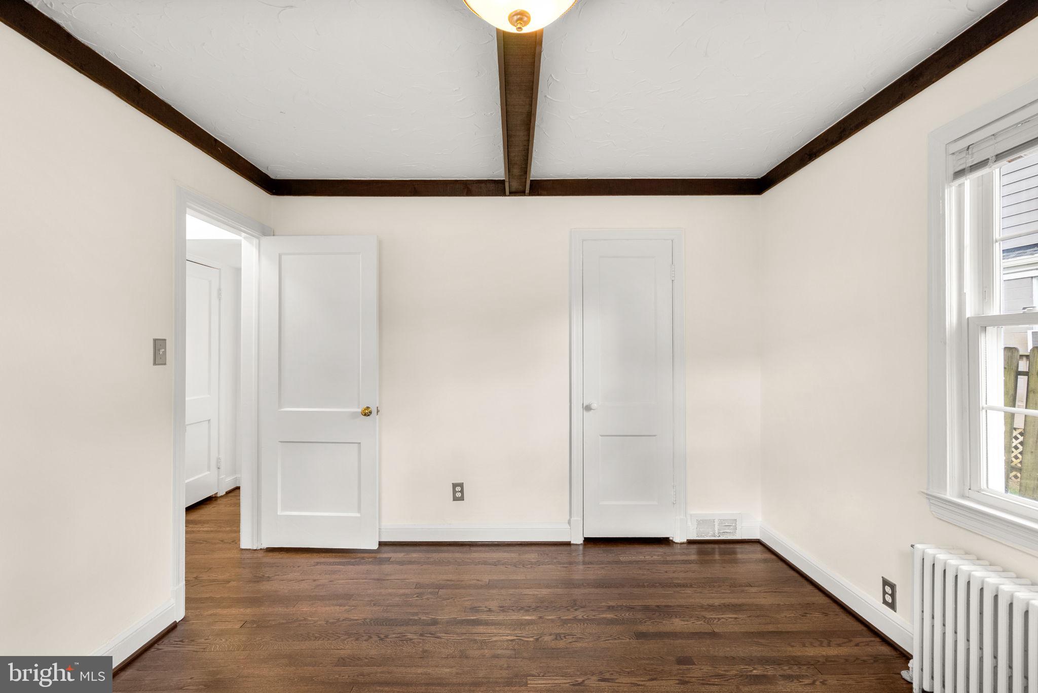 10603 South Dunmoor Drive Silver Spring, MD 20901 - Photo 17 of 41 a view of an empty room with window and wooden floor