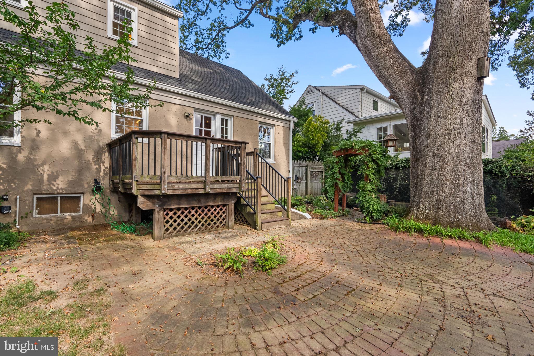10603 South Dunmoor Drive Silver Spring, MD 20901 - Photo 31 of 41 a view of a brick house with a small yard and large tree
