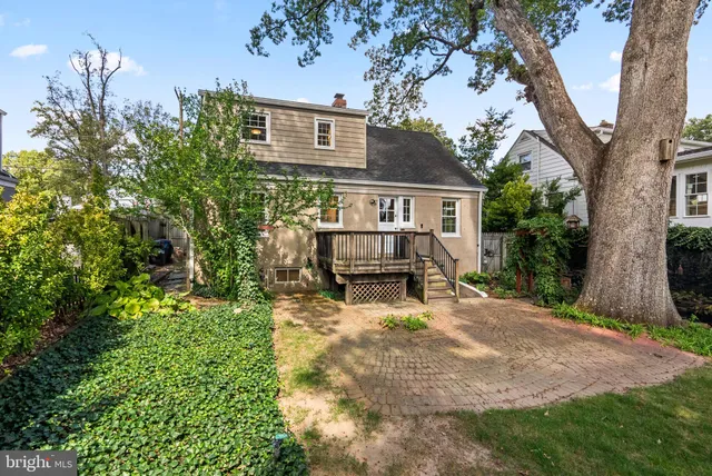 a view of house with backyard and sitting area
