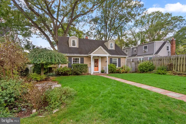 a front view of a house with yard and green space