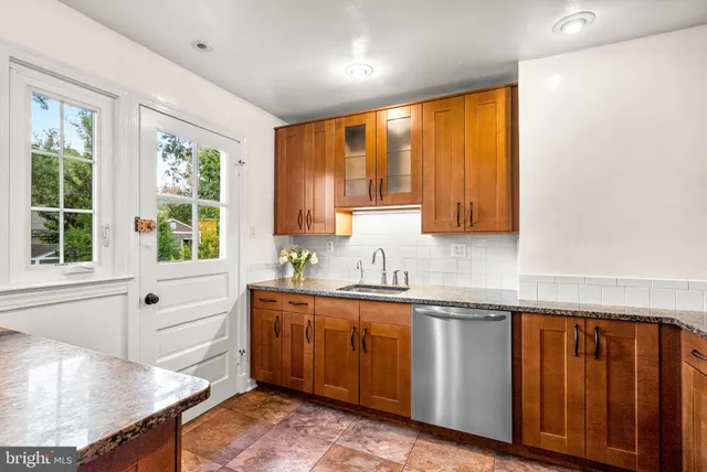 a kitchen with a window a sink and cabinets