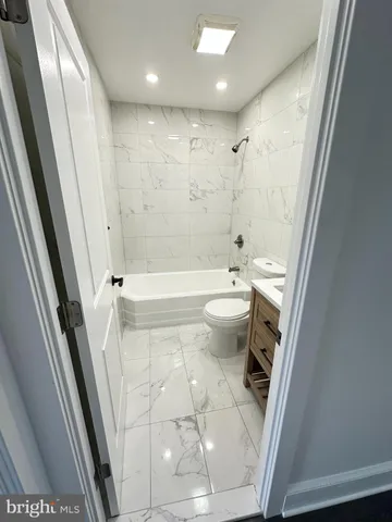 a bathroom with a sink a toilet and a shower