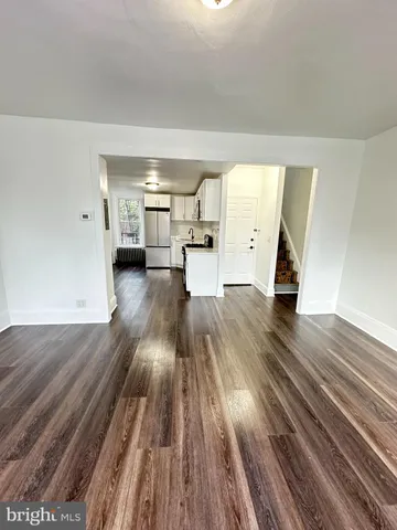 a view of a room with wooden floors and window