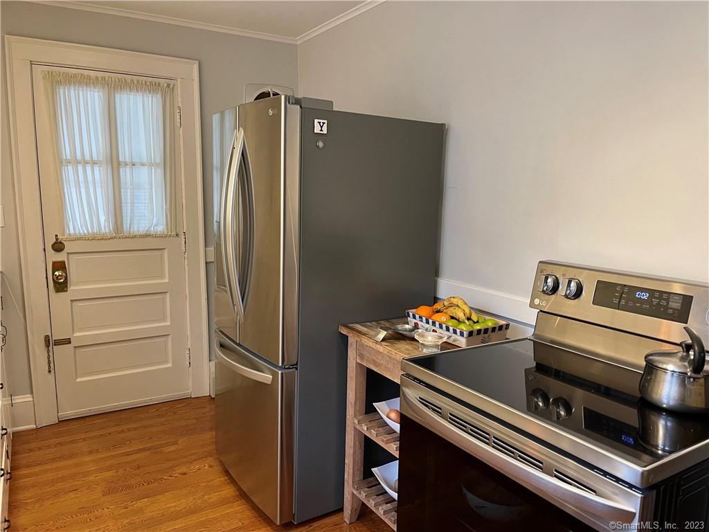 43 Neck Road Madison, CT 06443 - Photo 18 of 33 a kitchen with a stove and a refrigerator