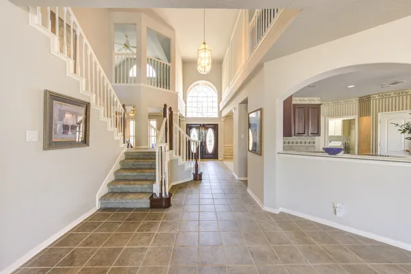 a view of an entryway with wooden floor and a living room