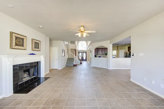 a view of a livingroom with an empty space and a fireplace