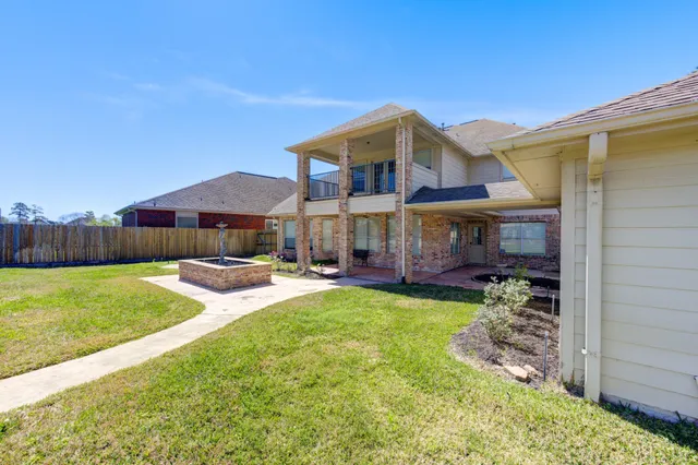 a view of a house with backyard and sitting area