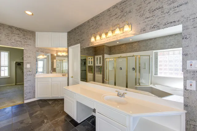 a bathroom with a sink and mirror