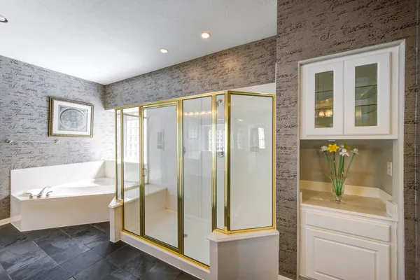 a bathroom with a bathtub and a shower