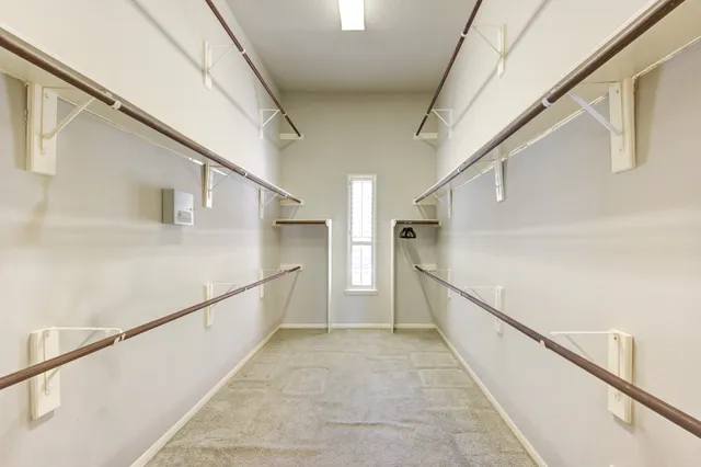 a view of an empty room with a fireplace and a window
