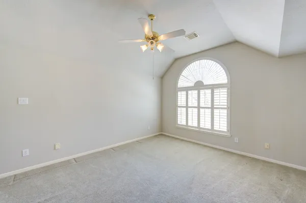 a view of an empty room with a fan