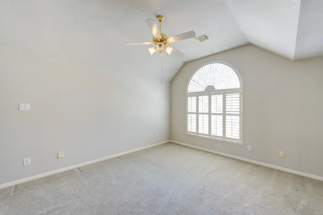 a view of an empty room with a fan
