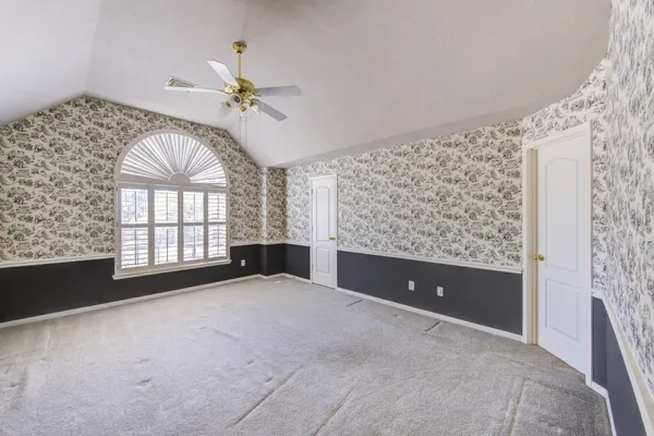 a living room with stainless steel appliances kitchen island granite countertop furniture a rug and a large window