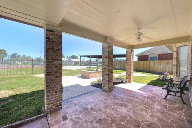 a view of a porch with furniture and a yard