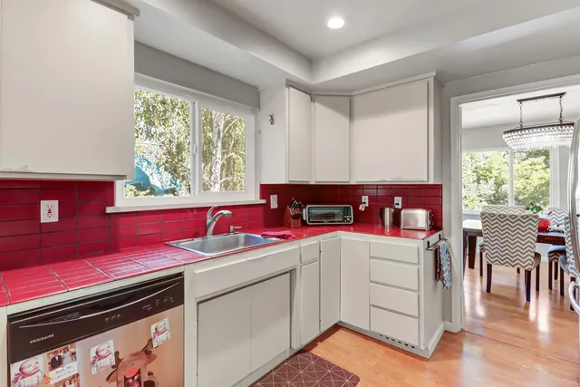 a bedroom with a bed two lamps and a large window