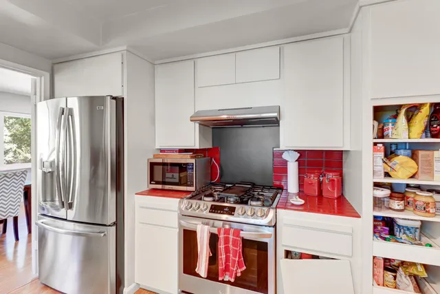 a large bed sitting in a bedroom next to a lamp