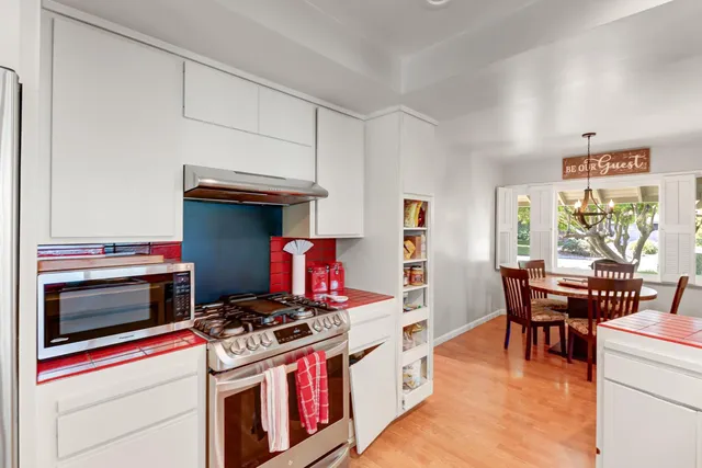 a bathroom with a granite countertop sink a mirror and a shower
