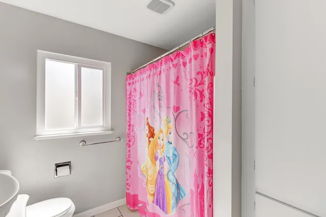 a living room with furniture pool table and a large window