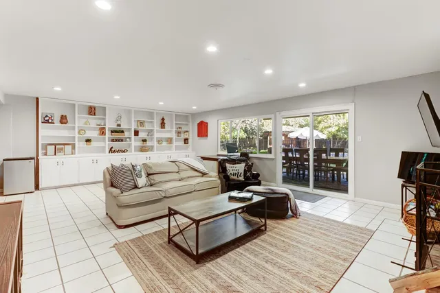a reading room with furniture and view of pool table