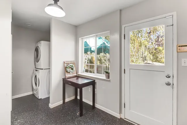 a view of a house with backyard and sitting area
