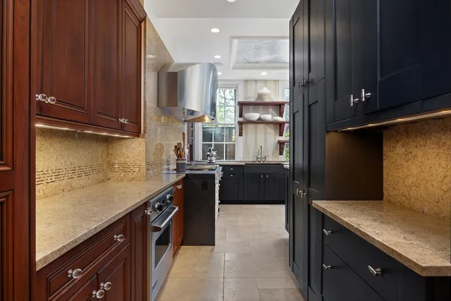 a kitchen with granite countertop stainless steel appliances and wooden cabinets