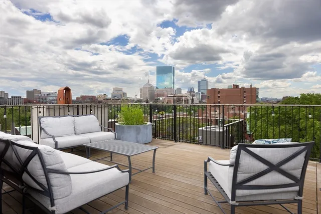 a roof deck with a table and chairs