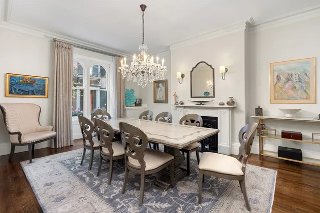 a dining room with furniture a chandelier and wooden floor