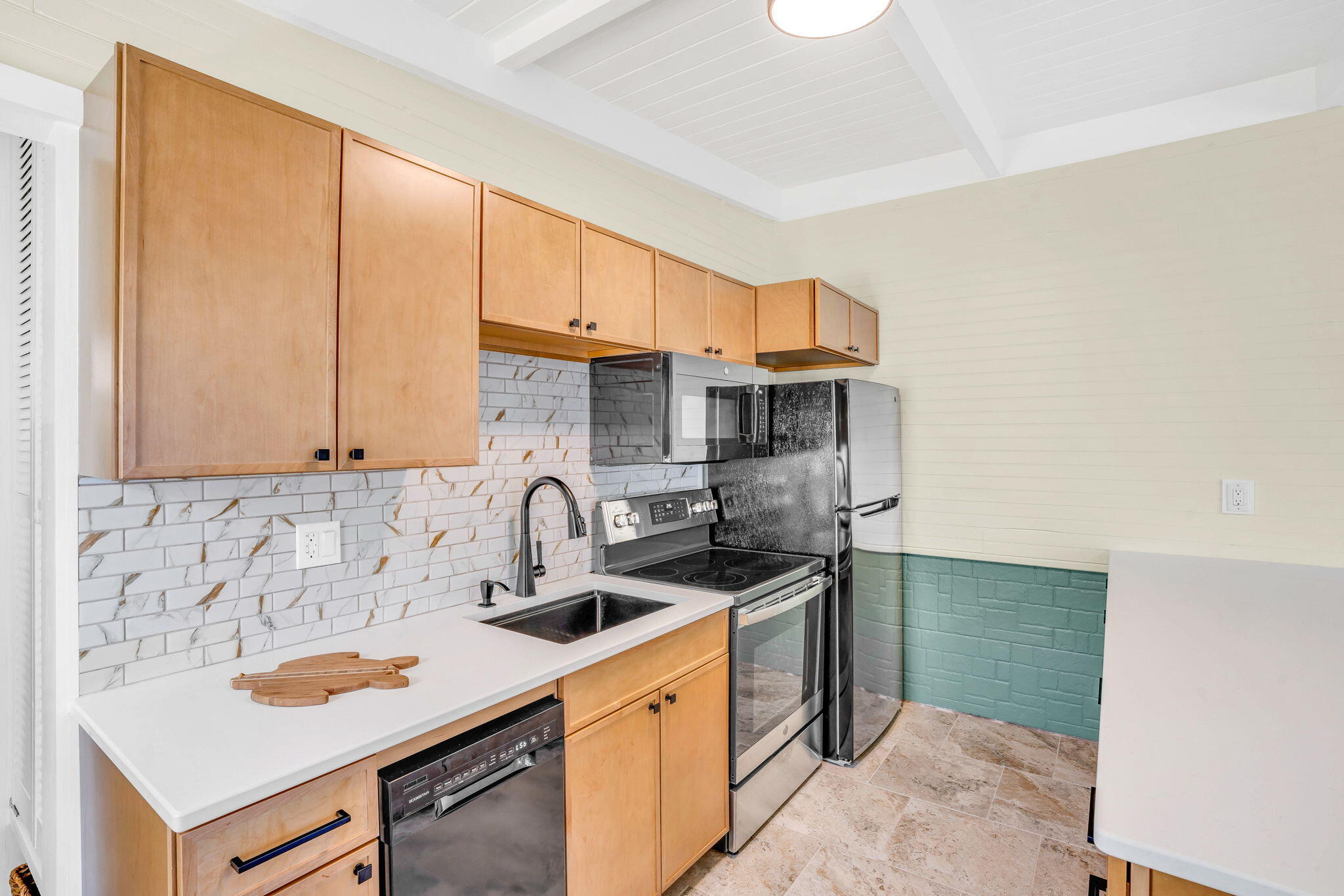41 Sadowski Causeway Key Colony Beach, FL 33051 - Photo 27 of 40 a kitchen with stainless steel appliances a sink stove and cabinets