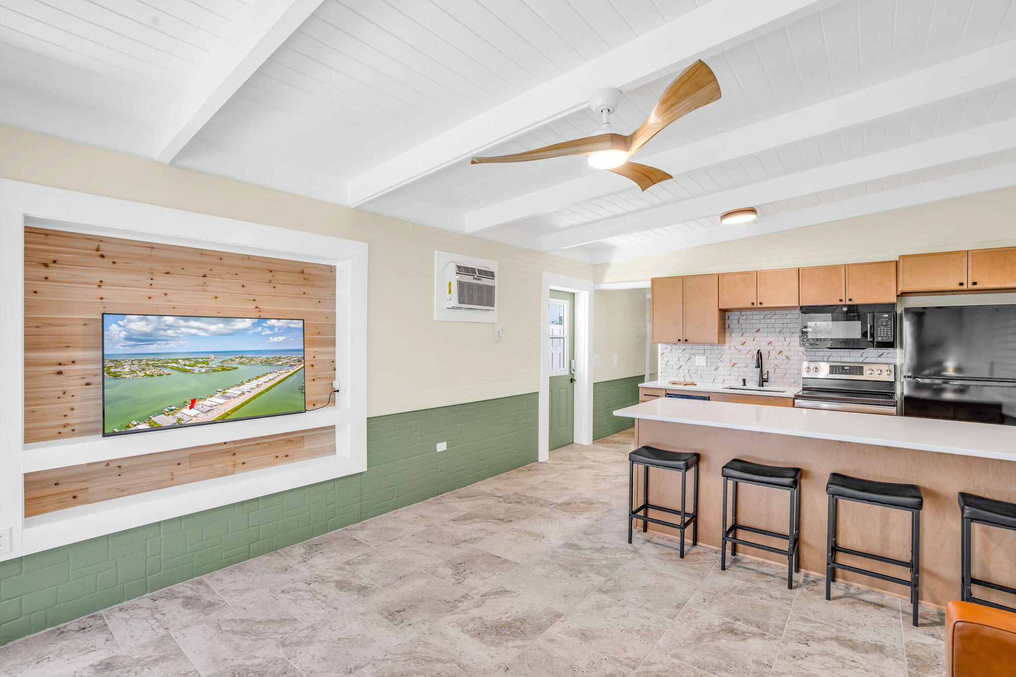 41 Sadowski Causeway Key Colony Beach, FL 33051 - Photo 30 of 40 a kitchen with stainless steel appliances kitchen island granite countertop a refrigerator and microwave