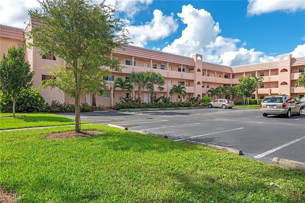 200 Forest Lakes Boulevard, Unit 201 Naples, FL 34105 - Photo 2 of 12 a house with garden in front of it