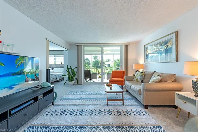 a living room with furniture rug and window