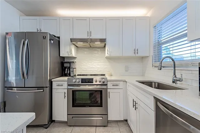 a kitchen with a stove sink and refrigerator