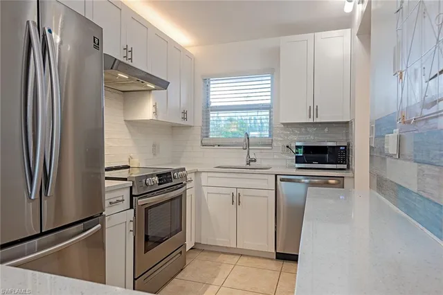 a kitchen with a stove microwave and a refrigerator