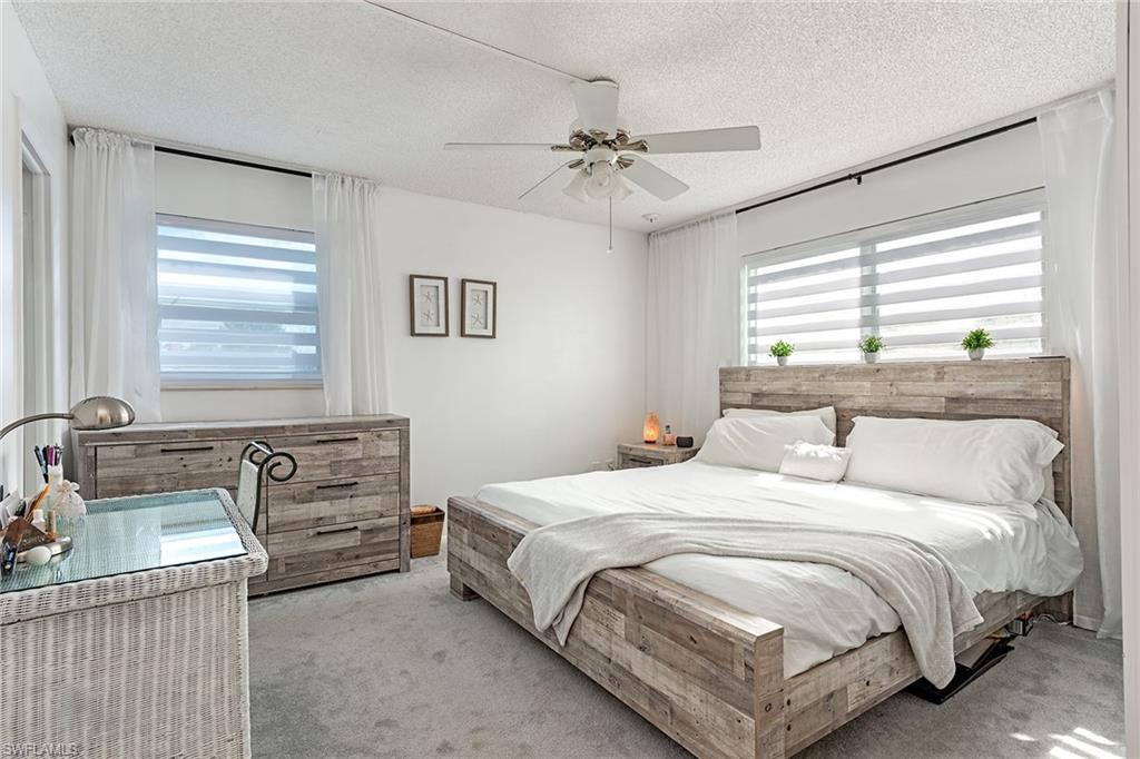 200 Forest Lakes Boulevard, Unit 201 Naples, FL 34105 - Photo 8 of 12 a bedroom with a bed and window